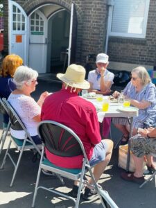 Some of the church community enjoying the centenary barbecue outside.